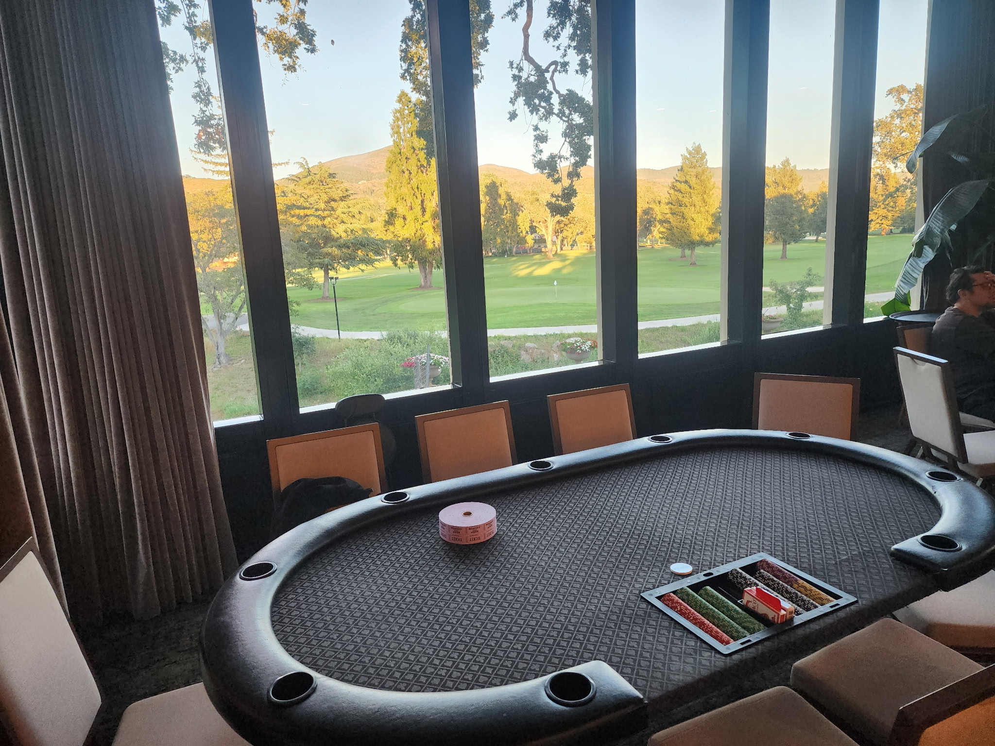 Casino party poker table set up at a real event with a scenic golf-course view