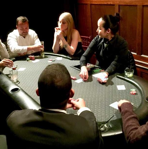 CPD poker dealer running a private cash-style Texas Hold'em table for event guests