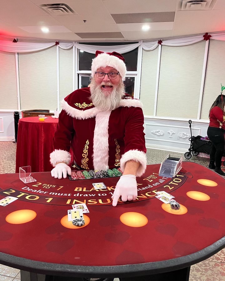 CPD dealer in Santa costume running a holiday casino party blackjack table
